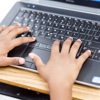 photo of student hands on a laptop